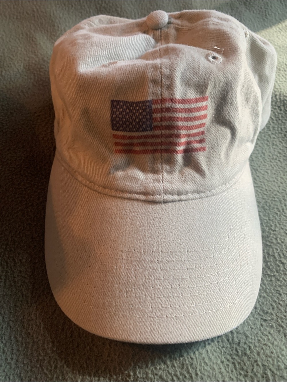 Never worn Otto tan had with printed American flag on front. Adjustable strap.